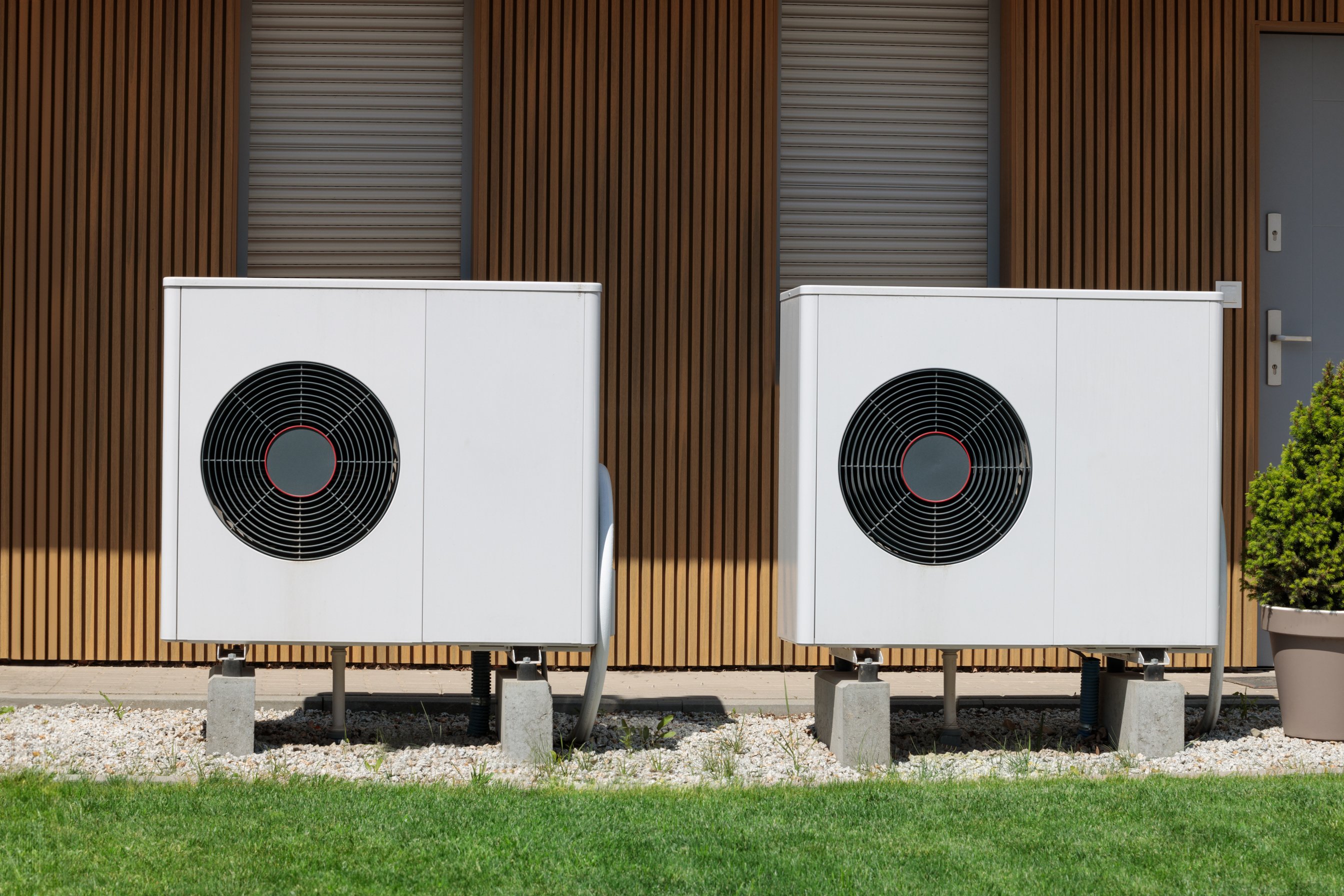 Modern house with renewable energy: air source heat pumps installed on the front.