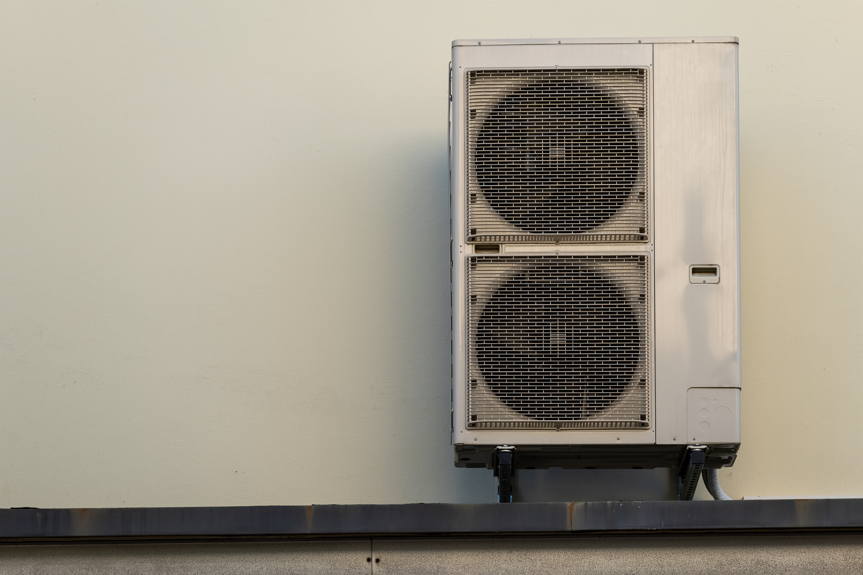 a heat pump on a house wall